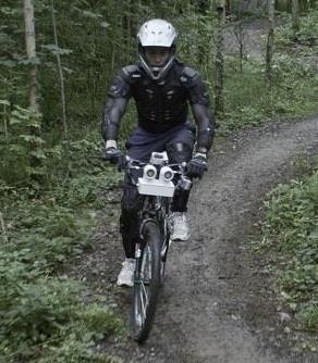 Figure 2 Dan Smith, completely blind, rides an Ultra-Bike through woodland [H,I].