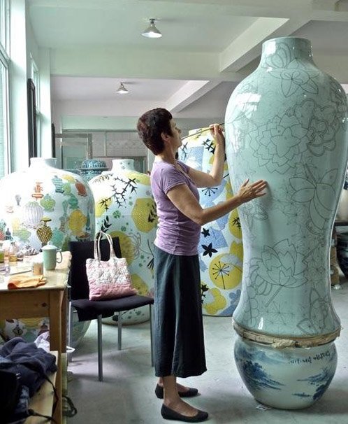 Aylieff Painting Fencai in the Studio (left); Aylieff’s Jingdezhen Tornado Tower Installation, Qatar (right).