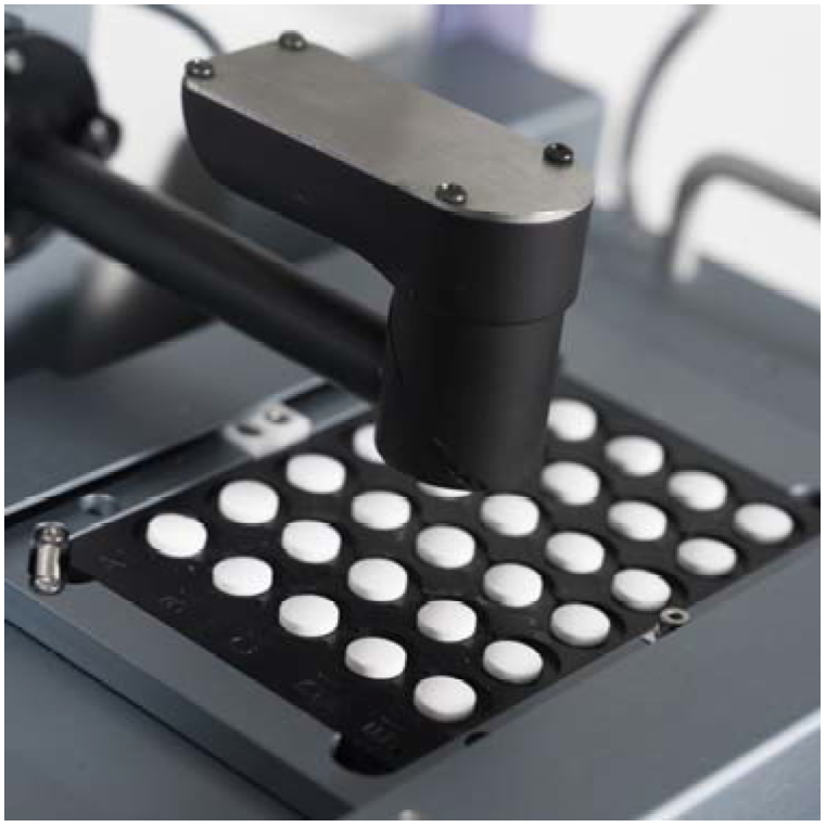 Figure 1 High throughput drug analysis-tablets being analysed in a Raman spectrometer as used in FSNI