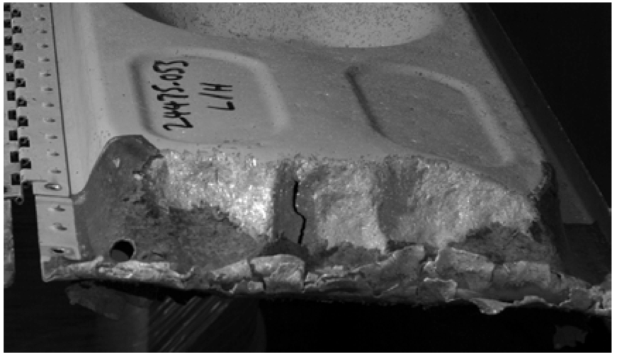 Fig 1 Runway debris damage to the leading edge of an undercarridge door of a transport aircraft